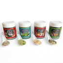 Four jars of SALTOPIA Infused Sea Salts’ Ultimate Veggie Lover Salts are lined up with white spoons and colorful labels, each featuring a unique vegetable seasoning blend.