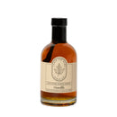An 8.4 fl oz (250 ml) clear glass bottle of Under The Bark Syrup Co Vanilla Maple Syrup, made in Minnesota, with a beige label and black cap, blending pure maple syrup and natural vanilla flavor for a rich taste.