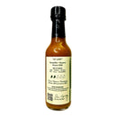 A glass bottle of Culture Hot Sauce Carpe Verdiem by Culture Hot Sauce with a black cap, featuring a label that lists ingredients, suggested uses, spiciness level, mission statement, and a QR code—perfect for those looking for a tropical green salsa or the vibrant taste of pineapple guava verde sauce.
