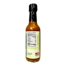 A glass bottle of Culture Hot Sauce Carpe Verdiem by Culture Hot Sauce, featuring a black cap, displays the nutrition facts label and a green panel with text, along with an American flag indicating it is made in the USA.