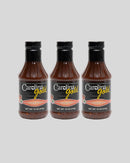 Three identical bottles of Gourmet Carolina Gold Hot Vinegar Pepper Carolina Gold BBQ Sauce with black caps and labels featuring yellow and white text.