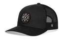 The Haka Hat Waco Trucker Hat is a black snapback featuring a curved bill, black mesh back, and a round embroidered "WACO X" patch in white—crafted in classic HAKA signature 5.0 style.