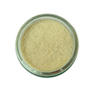 A clear glass jar of SALTOPIA Infused Sea Salts "Saltopia Wasabi Salt: WAS-AB-HAPPENIN," fine light beige powder viewed from above on a white background—the perfect sushi companion and sea salt infusion.