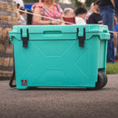 Seafoam 55 quart wheeled cooler by Bison, featuring black latches and a textured surface.