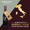 A bottle of Georgetown Olive Oil Co. Wild Blueberry Balsamic Vinegar from Georgetown Olive Oil Co. is made with premium quality barrel-aged Italian balsamic vinegar from Modena and features a gold Italy map along with the text: Premium Quality Barrel Aged Italian Balsamic Vinegar.