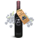 A bottle of Georgetown Olive Oil Co. Wild Blueberry Balsamic Vinegar with a brown tag, surrounded by fresh blueberries and green leaves. The label displays the Georgetown Olive Oil Co. brand, highlighting the rich tradition of Modena, Italy.