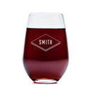 Stemless wine glass from The Diamond set by Swanky Badger, filled with red wine and featuring a diamond engraved design that reads SMITH.