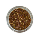A glass jar of SALTOPIA Infused Sea Salts' Saltopia Za'atar Spice Blend, featuring a mix of green, brown, and beige seeds and herbs, is seen from above against a white background.