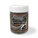 A clear glass jar with a white lid holds Saltopia Za'atar Spice Blend by SALTOPIA Infused Sea Salts. The brown label features spice images, a bowl, the product name, and website. This classic Middle Eastern seasoning highlights sumac.
