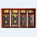 Introducing the Spice Wheel Mediterranean Spice Essentials Gift Set—a beautifully curated collection by Spice Wheel. This elegant gift box features four jars of authentic Mediterranean spices: Brown Za’atar, Green Za’atar, Aleppo Pepper, and Sumac. Each jar is topped with a gold lid and adorned with a stylish brown or black label, all neatly arranged side by side for a sophisticated presentation.
