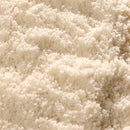 Close-up of a large amount of The Spice Lab Fleur de Sel Sea Salt crystals, showcasing their coarse, white grainy texture in natural light.