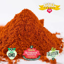 A vibrant heap of reddish-brown chile powder from the Rico Rico Chile Powder 3 Pack Bundle—featuring Ancho, Guajillo, and Arbol varieties—bears labels for NON GMO, 100% AUTHENTIC PRODUCTS, and GLUTEN FREE. This authentic ingredient is perfect for Mexican cuisine. Enjoy it as a gluten-free, non-GMO option that can be used on its own or alongside ancho or guajillo chile powders to add bold flavor to your favorite dishes.