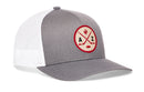 A gray and white Haka Hat Arizona Hockey Trucker Hat | AZ X Snapback from Haka Hat, featuring a mesh back and a round patch on the front with crossed hockey sticks, a cactus, and the letters A and Z.