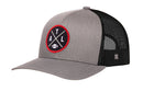 Introducing the Haka Hat Atlanta Trucker Hat, a stylish black ATL X Football Snapback by Haka Hat. This hat features a gray and black color scheme with a round front patch displaying crossed lines, the letters A, T, L, and a small football icon. The classic trucker design also includes a black mesh back for breathability—an ideal choice for dedicated ATL football fans.