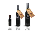 Three bottles of Georgetown Olive Oil Co 18 YEAR AGED Balsamic Vinegar Reduction, labeled 60ml, 200ml, and 375ml and arranged left to right in order of size. The two larger bottles feature a tan tag around the neck, reflecting the rich artisanal tradition of Modena balsamic craftsmanship from Georgetown Olive Oil Co.
