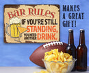 The Bar Rules - Metal Sign by Lone Star Art adds humor to your space: “If you’re still standing, you need another drink.” Fun gift idea with beer bottles, chips, and football design!.