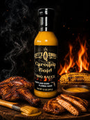 A bottle of Scott’s Smoked Q Carolina Gold Mustard BBQ Sauce for Pork, Chicken and Burgers—packed with bold, Southern-inspired flavor—sits among grilled chicken, corn on the cob, and a bowl of sauce, all set against the backdrop of a sizzling grill.