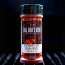 A bottle of BBQ Bros Rubs Kansas City Style BBQ Rub 3 oz from BBQ Bros Rubs rests on a grill, showcasing its black label decorated with flames and bold white text.