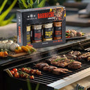 A barbecue grill loaded with assorted meats and vegetables sizzles outdoors, while in the foreground sits The Spice Lab Barbecue Seasoning Collection—a gift box set of four expertly labeled BBQ rubs by The Spice Lab, making it a perfect grilling gift. Lush greenery fills the background.