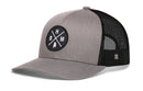 Haka Hat Birmingham Trucker Hat in gray and black, featuring a circular patch with crossed lines, the letters B, H, and M, and a small silhouette of Alabama.