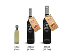 Three bottles of Georgetown Olive Oil Co. products in different sizes are displayed: a clear 60ml bottle, a black 200ml bottle labeled "Georgetown Olive Oil Co. Bourbon White Balsamic," and a black 375ml bottle labeled "Georgetown Olive Oil Co. Aged White Balsamic Vinegar from Modena, Italy." Each bottle features text labels indicating their volumes.