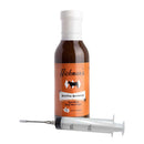 A bottle of Hickman's BBQ Bovine Bonanza Beef Injectable Marinade stands upright beside a large clear plastic injector, forming a practical marinade kit from Hickman's BBQ that's perfect for infusing deep flavor into every cut of brisket.