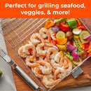The Braize Large Stainless Steel Grill Basket with Removable Handle, Basting Brush & Scrub Sponge is shown filled with shrimp, bell peppers, zucchini, mushrooms, and red onions. Text above reads: Perfect for grilling seafood, veggies & more!.