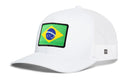 Introducing the Haka Hat Brazil Flag International Trucker Hat | Brazilian Snapback by Haka Hat—a white mesh baseball cap showcasing a bold rectangular patch of the Brazilian flag on the front panel. This stylish snapback is perfect for fans and supporters alike, offering a comfortable fit thanks to its classic Brazilian trucker hat design. Add a standout piece to your collection with this eye-catching accessory from Haka Hat.