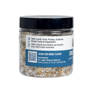 Clear plastic jar of B.T. Leigh’s Garlic & Oregano Finishing Salt filled with coarse kosher salt flakes and dried herbs, featuring a label with serving suggestions and a QR code.