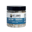 Clear plastic jar of B.T. Leigh’s Garlic & Oregano Finishing Salt with a black lid and a blue and white product label.