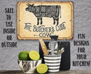 Decorative sign with butcher's cut diagram on a kitchen wall with utensils and limes below.
