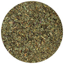 A close-up view of The Spice Lab Organic Sweet Basil by The Spice Lab—dried green organic basil leaves, finely chopped and spread evenly in a circular frame against a white background—perfect for Italian-inspired cooking.