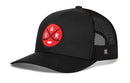 The Haka Hat Carolina Hockey Trucker Hat | Red CAR X Snapback features a black mesh back and a red circular patch on the front with two crossed hockey sticks, a puck, and the letters C, A, and R—delivering signature 5.0 trucker style that’s perfect for Raleigh, North Carolina hockey fans.