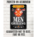 A Lone Star Art aluminum sign on a white brick wall reads: CAUTION MEN GRILLING BRING BEER, with grilling icons. Rust-, fade-, and peel-proof, it's a great grilling decor or housewarming gift.