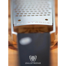 Close-up of the Dalstrong Professional Coarse Wide Cheese Grater with G10 handle, featuring the engraved brand name and logo on a wooden surface. The black handle highlights this premium stainless steel grater.