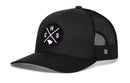 The Haka Hat Charleston Trucker Hat | CHS X Snapback features a black mesh design with a curved brim and ventilated side and back panels for signature comfort. The front is decorated with a circular patch displaying crossed lines, the letters C, H, S, and a subtle outline of South Carolina—a distinctive nod to the CHS X Snapback style from Haka Hat. This classic trucker hat is an essential piece for any Charleston fan.