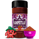 A bottle of Rico Rico Chipotle Morita Chile Powder Shaker, adorned with vibrant labeling, stands beside a small pink bowl of the rich chipotle powder and an adorable cartoon red chili pepper with a green stem and cheerful smile, embodying the smoky-savory flavor that brings authentic Mexican cuisine to life.