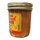 Guenther Apiary Arkansas Strawberry Creamed Honey comes in a small glass jar with a gold metal lid. The label lists ingredients as raw local honey and dried strawberries. Brand: Guenther Apiary.