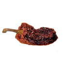 A single dried red chili pepper with a wrinkled texture and a brown stem, isolated on a white background—perfect for pairing with The Spice Lab’s Smoked Ghost Pepper Sea Salt to add fiery intensity and bold flavor to your culinary creations.
