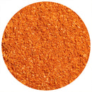 Close-up of orange-red powder, finely ground with a slightly coarse texture, spread evenly in a circle against a white background—The Spice Lab Best of the Bay Seasoning by The Spice Lab captures vibrant coastal flavor in every reduced salt sprinkle.