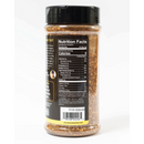 A clear plastic container of Chiles & Smoke Canyon Crust Beef Seasoning with a black lid is shown from the back. The label features nutrition facts, ingredients, a barcode, and the website chilesandsmoke.com at the bottom. Perfect as a robust BBQ rub for beef or a savory brisket rub, this versatile seasoning from Chiles and Smoke elevates any grilling experience.
