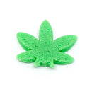 The Spice Lab Hemp Leaf Sprinkles CBD & THC Free by The Spice Lab are vibrant green, leaf-shaped candies with a textured surface that resemble cannabis leaves. Perfect for use as edible party decorations or as hemp leaf sprinkles to enhance your desserts, these candies are completely free of CBD and THC. Shown on a white background.