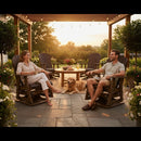 A woman and man relax at sunset on Kanyon Living Adirondack Poly Glider Swivel Chair Deluxe in Brazilian Walnut & Weathered Wood, with a golden retriever between them, surrounded by flowers, string lights, and recycled HDPE furniture.