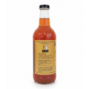 Guenther Apiary Apple Cider Vinegar with Honey & “Mother” comes in a clear glass bottle with a black screw cap and yellow label, containing orange-brown vinegar. Usage instructions and recommendations are printed in black text on the back.