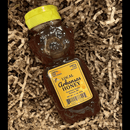 DDR BBQ Supply Guenther Apiary raw wildflower honey in a classic bear-shaped squeeze bottle nestled in paper filler.