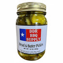 DDR BBQ Supply Bread & Butter Pickles Pint – 16 oz comes in a jar with a gold lid and blue and red label featuring a white star. Enjoy these sweet and tangy pickles from DDR BBQ Supply with any meal or as a tasty snack.