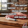 A Butcher BBQ Budget Meat Injector rests on a wooden cutting board in front of a raw cut of meat labeled with injection guides for beef, pork, turkey, chicken, venison, and lamb.
