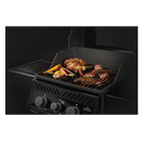 DDR BBQ Supply porcelain-enameled cast iron reversible griddle on a Napoleon Rogue gas grill cooking vegetables and meat