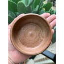 DDR BBQ Supply handmade ceramic shave bowl with a rustic brown finish for lathering soap pucks held in a hand.
