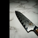 DDR BBQ Supply Spaceman Knives petty chef knife with Damascus steel blade and olive wood handle on marble surface